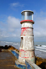 Long Shot of a Beautiful  Small Lighthouse next to the Ocean on a SOnny Day at Ecuador