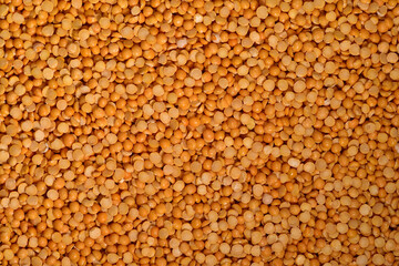 Dried yellow split peas background. Vegetarian ingredient.