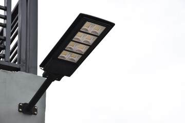 Mini solar and lamp panels installed on the wall of the house, soft and selective focus, concept for using natural power from the sunlight at home in daily life.