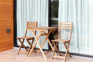 Brown wooden chairs and brown wood table on the balcony - obrazy, fototapety, plakaty