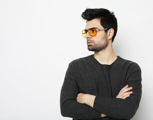 Obraz premium Elegant young handsome man in smart casual wear and sunglasses.