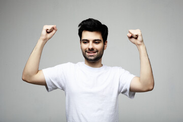 Fototapeta premium young man celebrating victory over white background