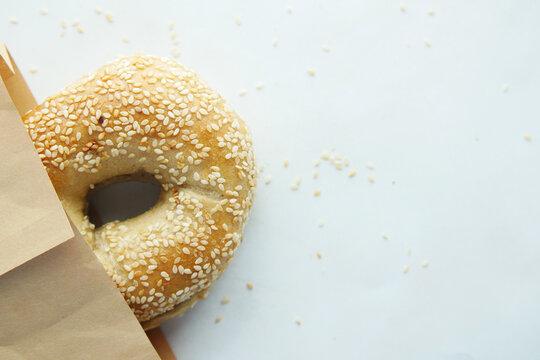 bagel and paper packet on white background 