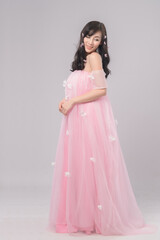 Portrait of beautiful asian woman bride in pink dress. Thai model posing in studio just married wedding concept.