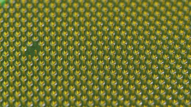Soket pins on computer CPU processor in light of different colors.Technology and development concept. Computer technology and hardware maintenance or repair. Electronic circuitry within computer