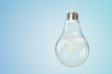 Light bulb on light blue background