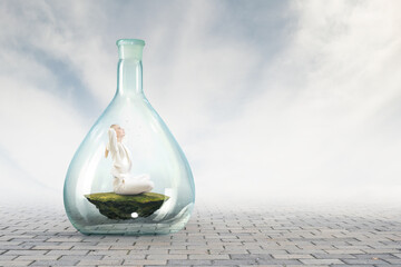 Business woman doing yoga in lotus pose inside glass bottle