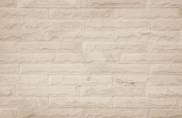 Empty background of wide cream brick wall texture. Beige old brown brick wall concrete or stone textured, wallpaper limestone abstract flooring/Grid uneven interior rock. Home decor design backdrop.