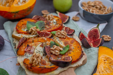 home made autumn pizza with pumpkin and figs