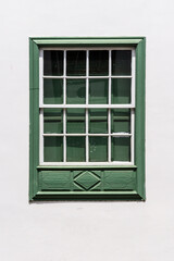 Fototapeta na wymiar Traditional green painted window in canarian colonial style house in the old town of Santa Cruz de La Palma, in the quarter of San Sebastian, also known as La Canela