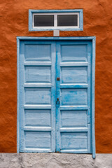 Obraz na płótnie Canvas Traditional blue painted door in canarian colonial style house in the old town of Santa Cruz de La Palma, in the quarter of San Sebastian, La Canels