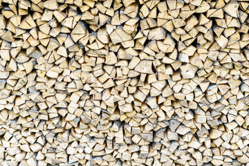 Dried beech wood ready for heating. Wooden pile in a stack. Chopped firewood logs dried on a pile. Wood background texture.