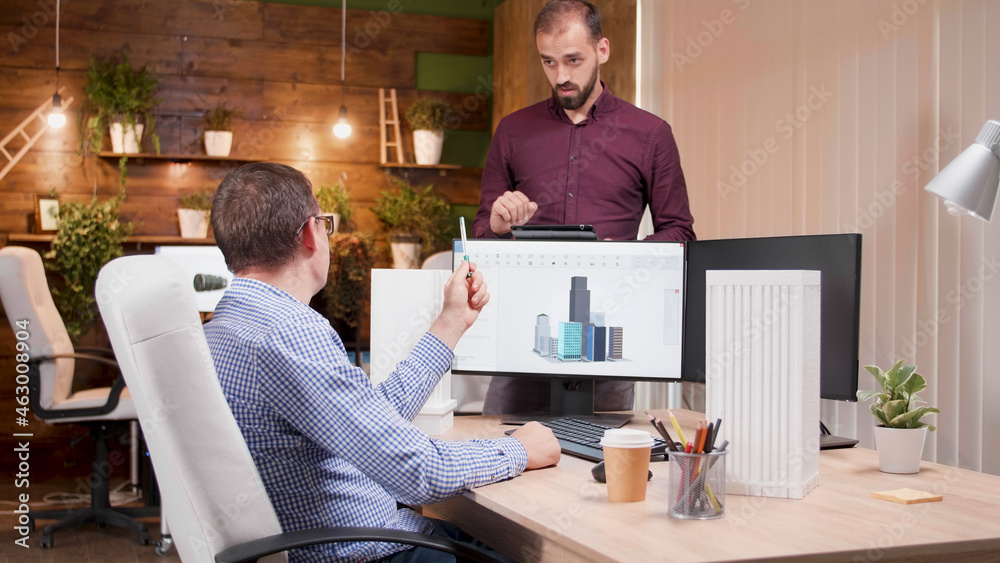 Poster Man architect explaining building construction structure to his engineer collegue developing new architectural prototype. Creativity team working in architecture industry planning technical maquette