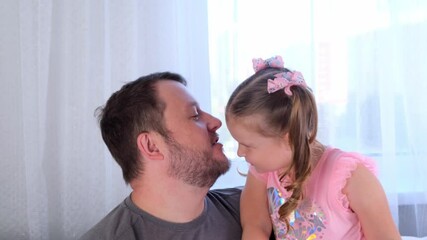 sweet Little daughter 3 years old and father gently hug and have fun at home. have fun with your baby, fool concept. fathers day. parenting, relationships between children and parents