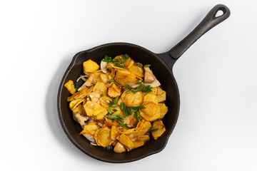 fried potatoes in a black pan on a white background