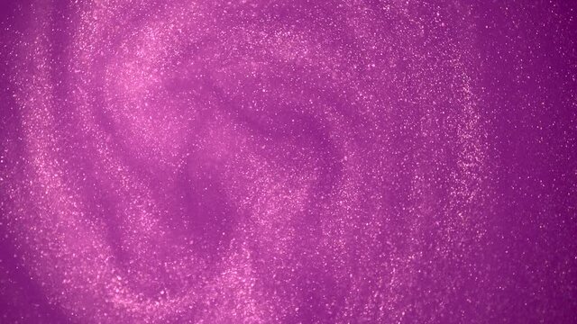 Pink glitter abstract background. Shiny liquid pink paint flows slowly onto the surface. Holidays, new year, fashion, abstract art concept video