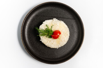 boiled white rice on a black plate on a white background