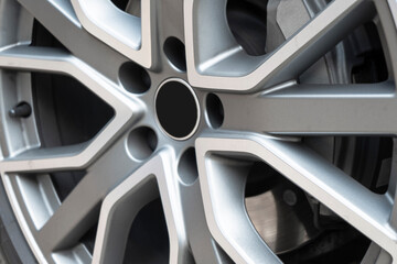 Car alloy wheel texture background. New alloy wheel for a car. Modern alloy rim. Car wheel disc.