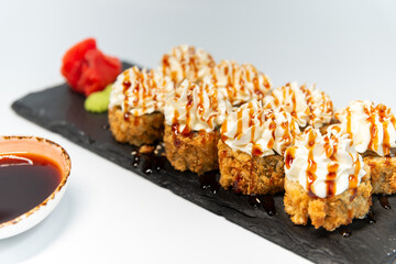 Tempura with an eel on a blackboard on a white background close up