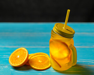Cold drink with oranges in jar