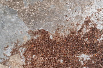 Old stained worn out rusty metal background. Corrosion of iron with streaks of rust. Finely cracked texture grey paint