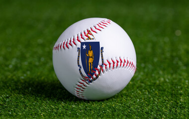 Baseball with Massachusetts flag on green grass background, close up