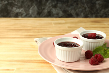 Concept of tasty food with raspberry jam on wooden table