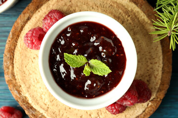 Concept of tasty food with raspberry jam on wooden background