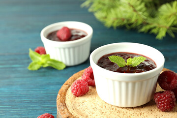 Concept of tasty food with raspberry jam on wooden background