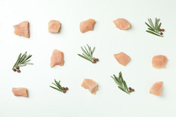Flat lay composition with slices of raw chicken fillet on white background