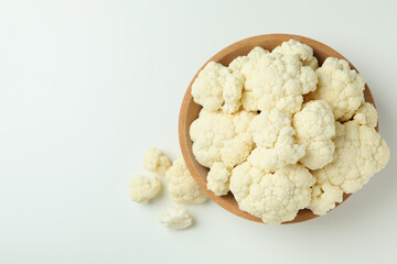 Slices of fresh juicy cauliflower in bowl on white background