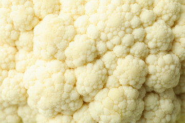 Slices of fresh juicy cauliflower all over background
