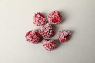 Group of frozen raspberry on light gray background