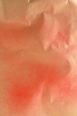 Fototapeta premium red spray paint on gold colored paper