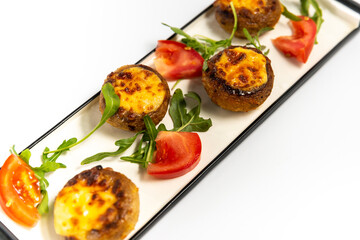 champignons with cheese on a white background
