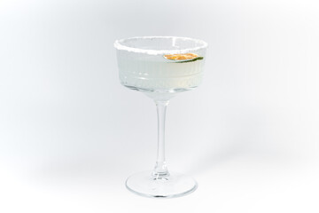 white cocktail decorated with salt and lime on a white background, cocktail close up, summer cocktail, martini cocktail