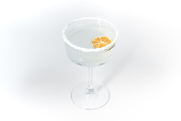 white cocktail decorated with salt and lime on a white background, cocktail close up, summer cocktail, martini cocktail