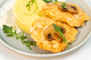 Chicken fritters with mashed potatoes on a white background close up 