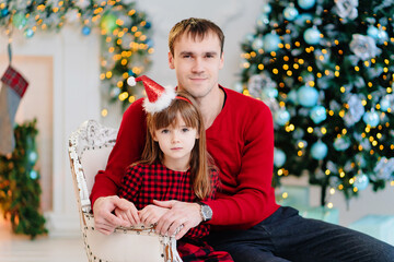 dad and daughter at the Christmas tree. happy family winter holidays.