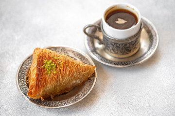 Small cup of Turkish coffee and Turkish baklava