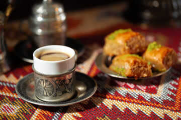 Small cup of Turkish coffee and Turkish baklava