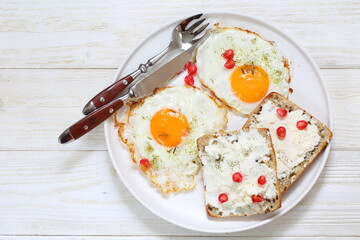 Scrambled eggs with ricotta sandwiches on white plate