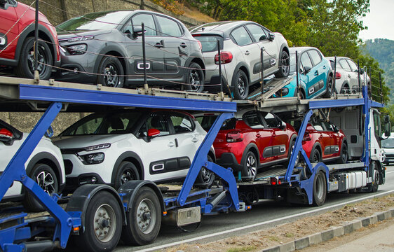 Car carrier. Cars transported on the car platform. New cars. No logo or brand.
