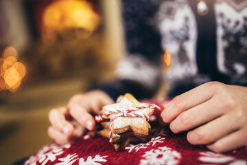Boy packing Christmas gingerbread cookies. Christmas and New Year eve at home.