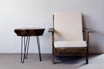 Wooden table for coffee. Loft style armchair. Wood texture. Furniture. In the room.