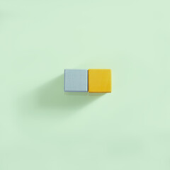 The adove view on two wooden cubes in two trend colors on the light background.