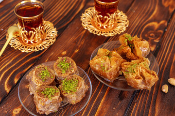 Fototapeta na wymiar Turkish sweet baklava with Turkish tea on wooden background