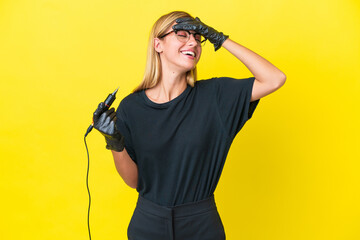Tattoo artist Uruguayan woman isolated on yellow background smiling a lot