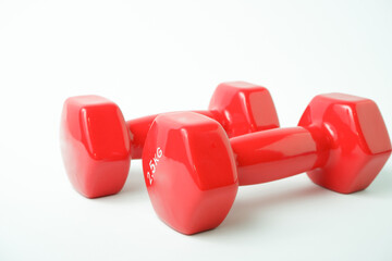Sport equipment. Two red dumbbells for fitness weighing 2 kg on a white background.