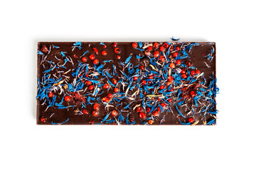 Dark chocolate with cherry, cranberry, pink pepper isolated on a white background.